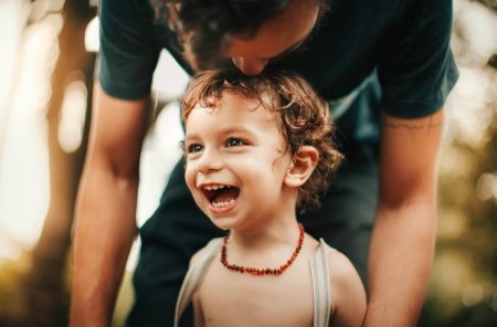 A joyful young child spending time with a parent